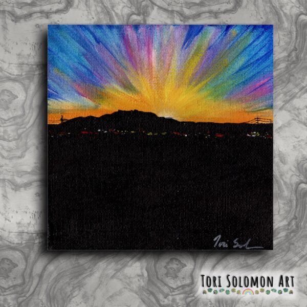 A gouache and acrylic painting on canvas of the sun rising over Sandia from the balloon fiesta field.