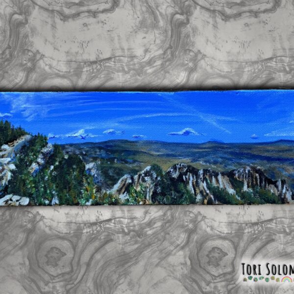 A painting of the view of the top of the Sandia Mountains with the mountains along the horizon and blue skies