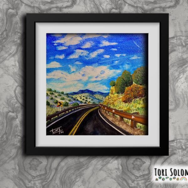 A scenic artwork of a winding road through Santa Fe's picturesque landscape, framed by clear blue skies and lush greenery.