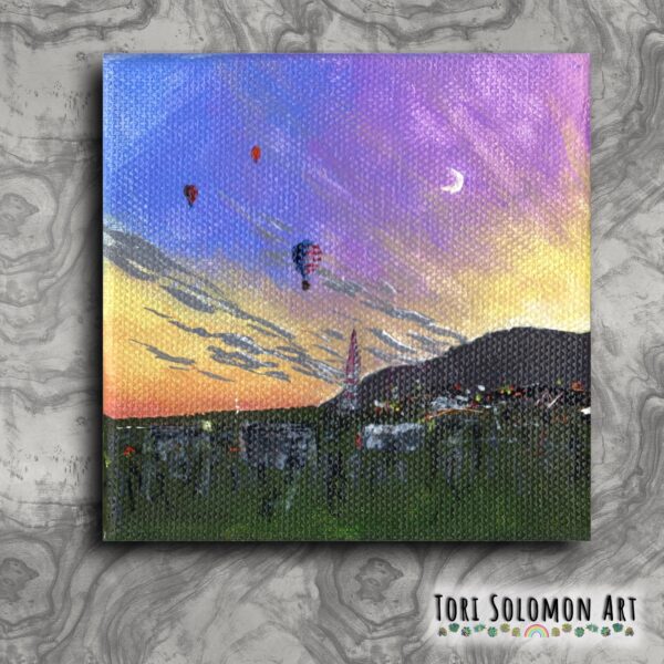 A colorful painting of a colorful and cloudy sunrise out from behind the mountains and three hot air balloons in the sky