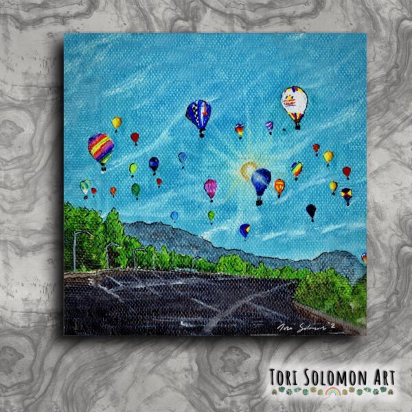 A small colorful painting of hot air balloons fiesta in the morning Albuquerque sky