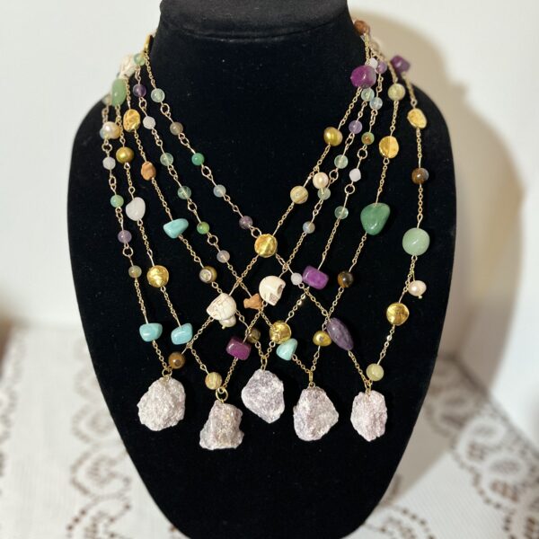 series of 7, 5 available, chosen by artist 20", lepidolite, fluorite, aquamarine, tiger's eye, pearl, shell, golden metal alloy beads, golden metal alloy chain, and some of these: vintage Mexican clay bird, howlite skull, agate, green aventurine, rose quartz, pistachio calcite